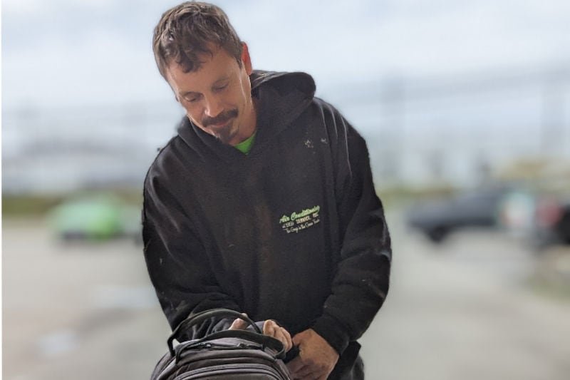 Technician preparing for air conditioning maintenance customers. Air Conditioning Service blog image.